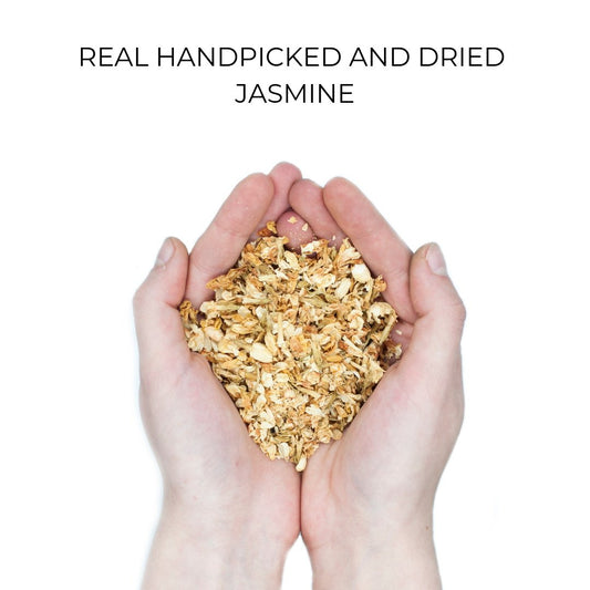 Close-up of two hands holding dried jasmine petals, highlighting the natural, organic material used in eco-friendly,.