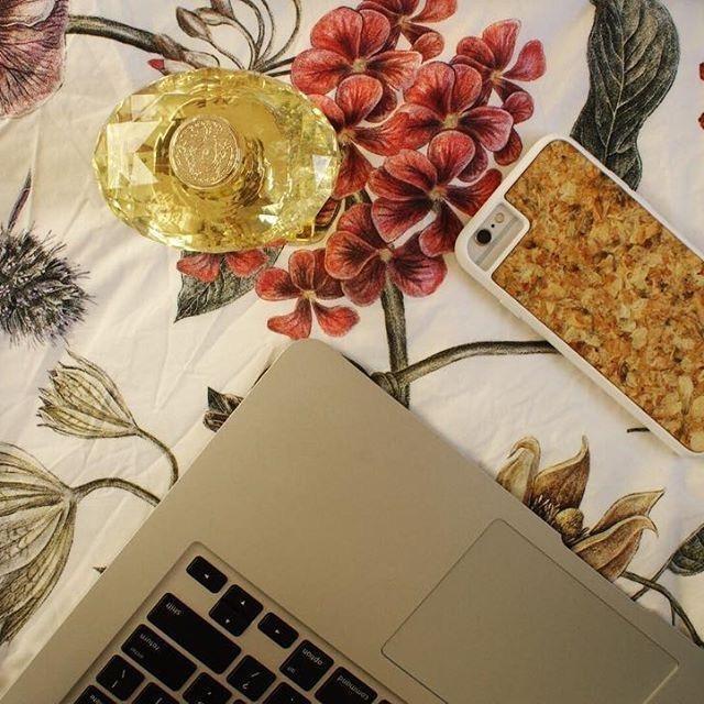 Handmade organic biodegradable phone case with natural wood texture on iPhone, eco-friendly sustainable design nearby laptop .