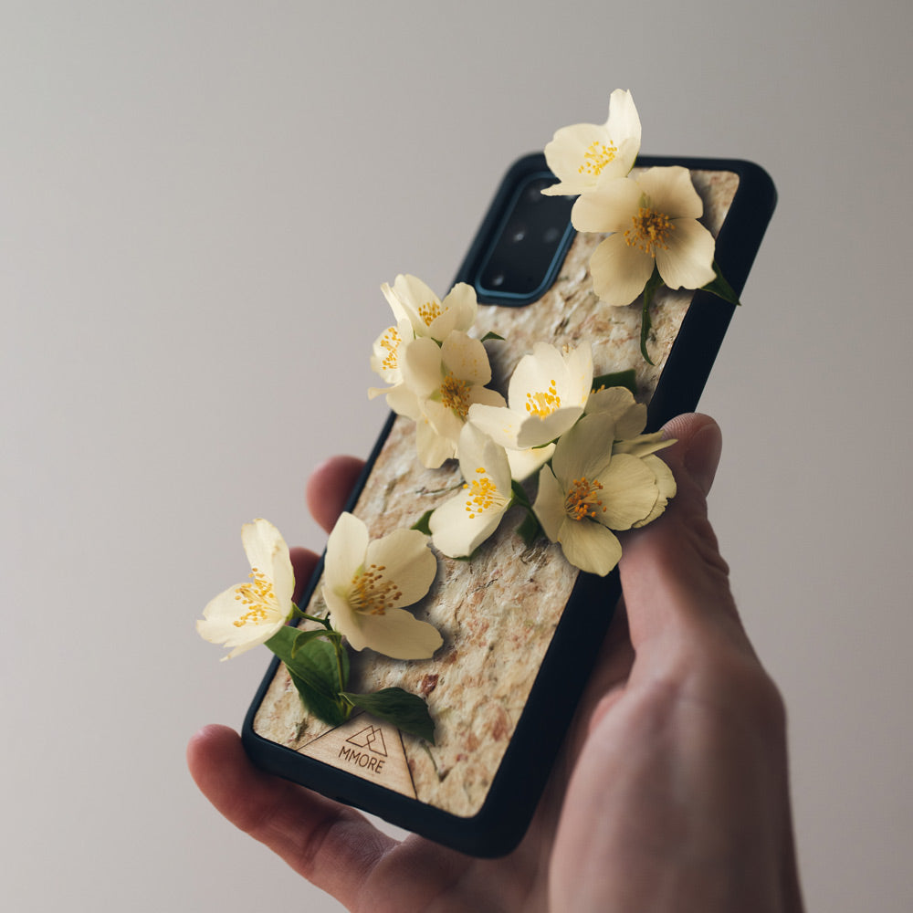 Black eco-friendly handmade phone case with biodegradable organic jasmine flower design, fits Google Pixel and iPhone models.